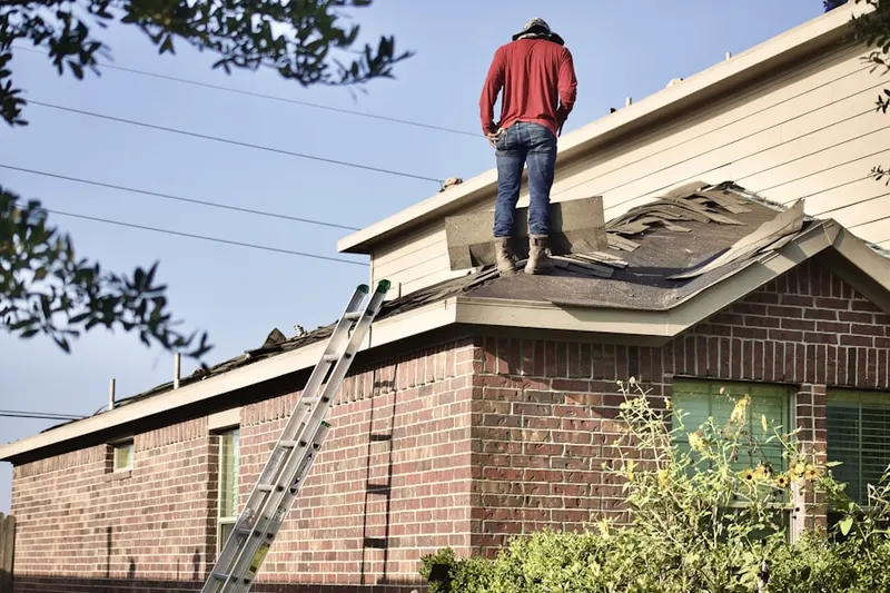 Professional roofer working on a residential roof in Candler Park